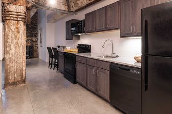 Model kitchen with black appliances at 99 Front, Memphis, TN